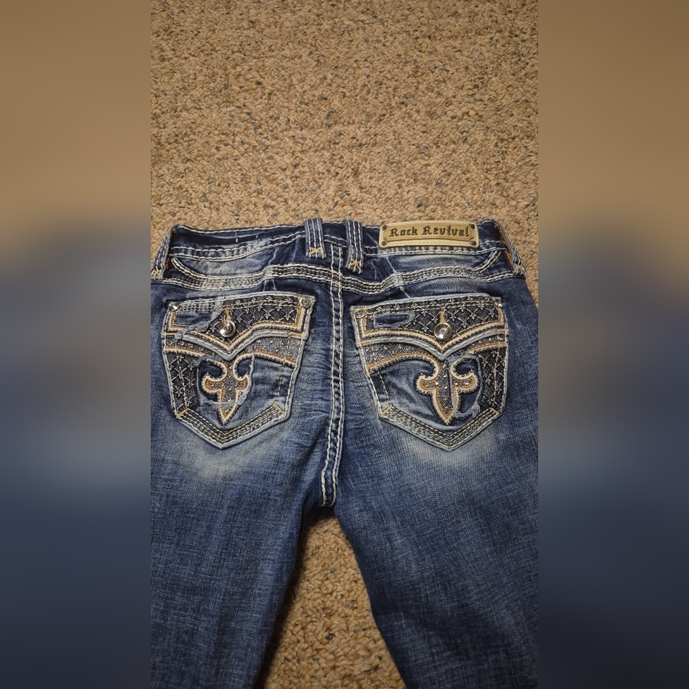 Rock Revival Distressed Blue Jeans with Silver Stitching
